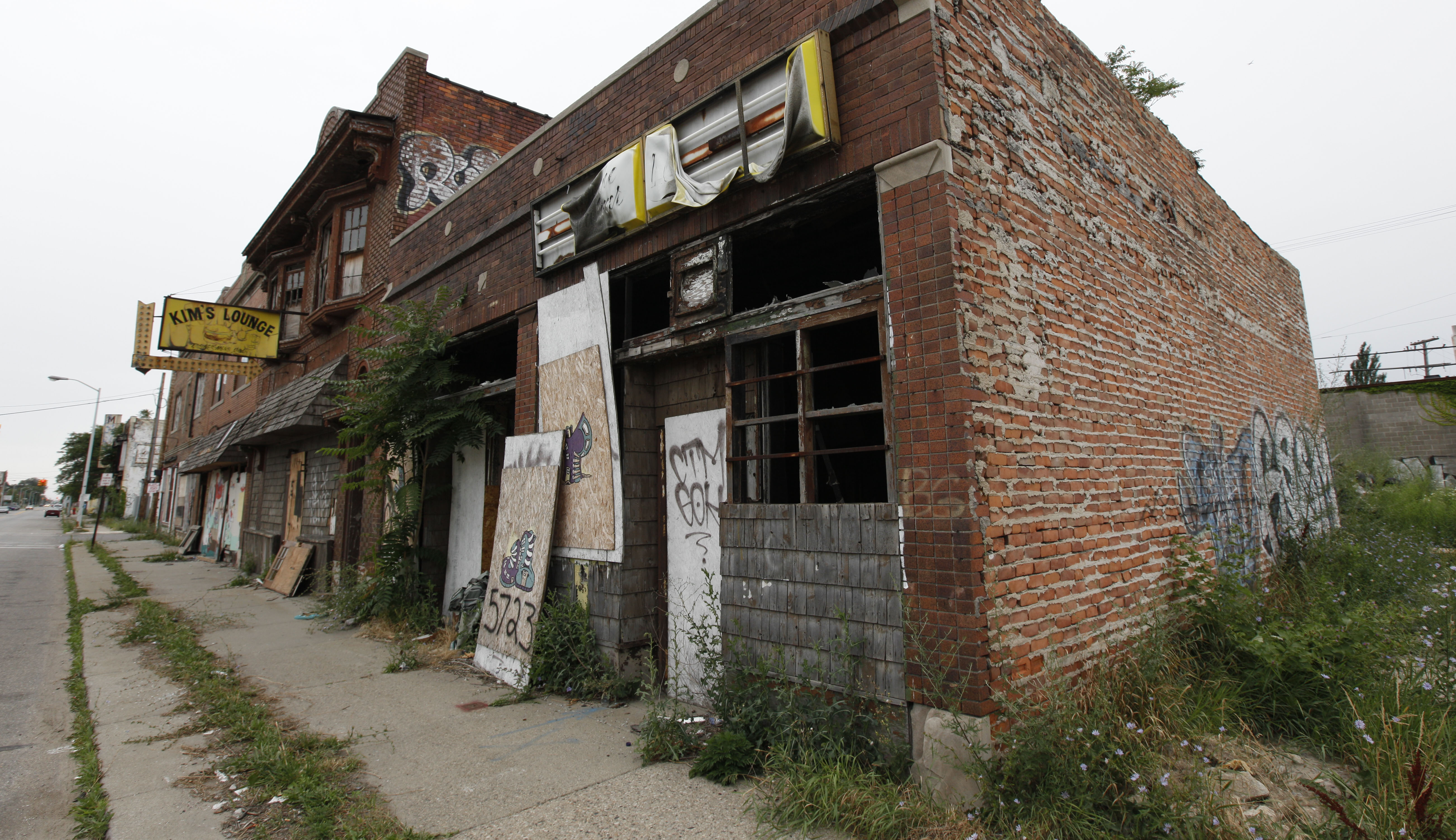 A section of vacant stores is shown in Detroit, Wednesday, July 27, 2011. Detroit’s mayor unveiled a plan that could determine what the city looks like as it fights for vitality, announcing that neighborhoods will receive different kinds of services depending on the condition of homes, how many people live there and the level of blight. His plan isn’t really about shrinking Detroit _ the 139-square-mile city’s boundaries aren’t receding. He instead wants to encourage redistribution of what’s left of Detroit’s population into areas where people still live, where houses aren’t about to cave in and where the city’s scant resources won’t be spread dangerously thin. (AP Photo/Paul Sancya)