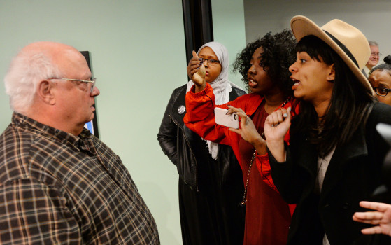 A group of demonstrators confront St. Paul teacher Jim Enders, whose comments offended them during a St. Paul School Board meeting at the school District Administrative Office in St. Paul on Tuesday, March 22, 2016. (Pioneer Press: John Autey)