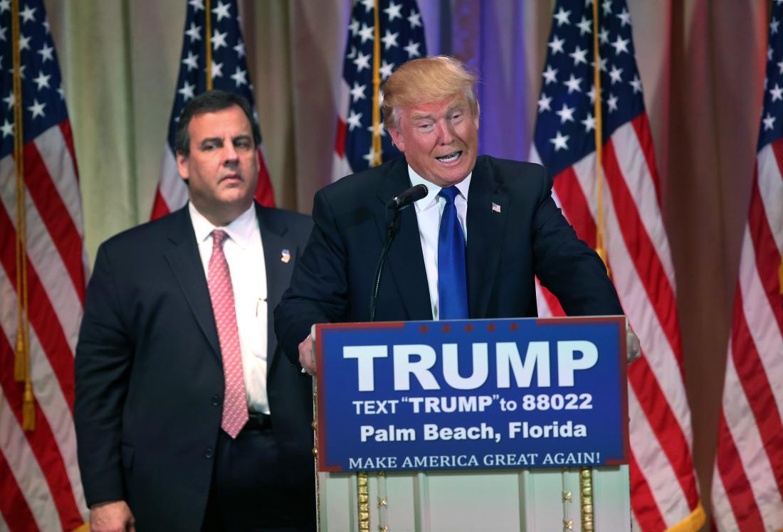 PALM BEACH, FL - MARCH 01: New Jersey Governor Chris Christie accompanies Republican Presidential frontrunner Donald Trump on the stage at a press conference on March 1, 2016 in Palm Beach, Florida. Christie stood by, often distracted, as Trump held a press conference at his Mar a Lago Club after the polls closed on Super Tuesday. (Photo by John Moore/Getty Images)