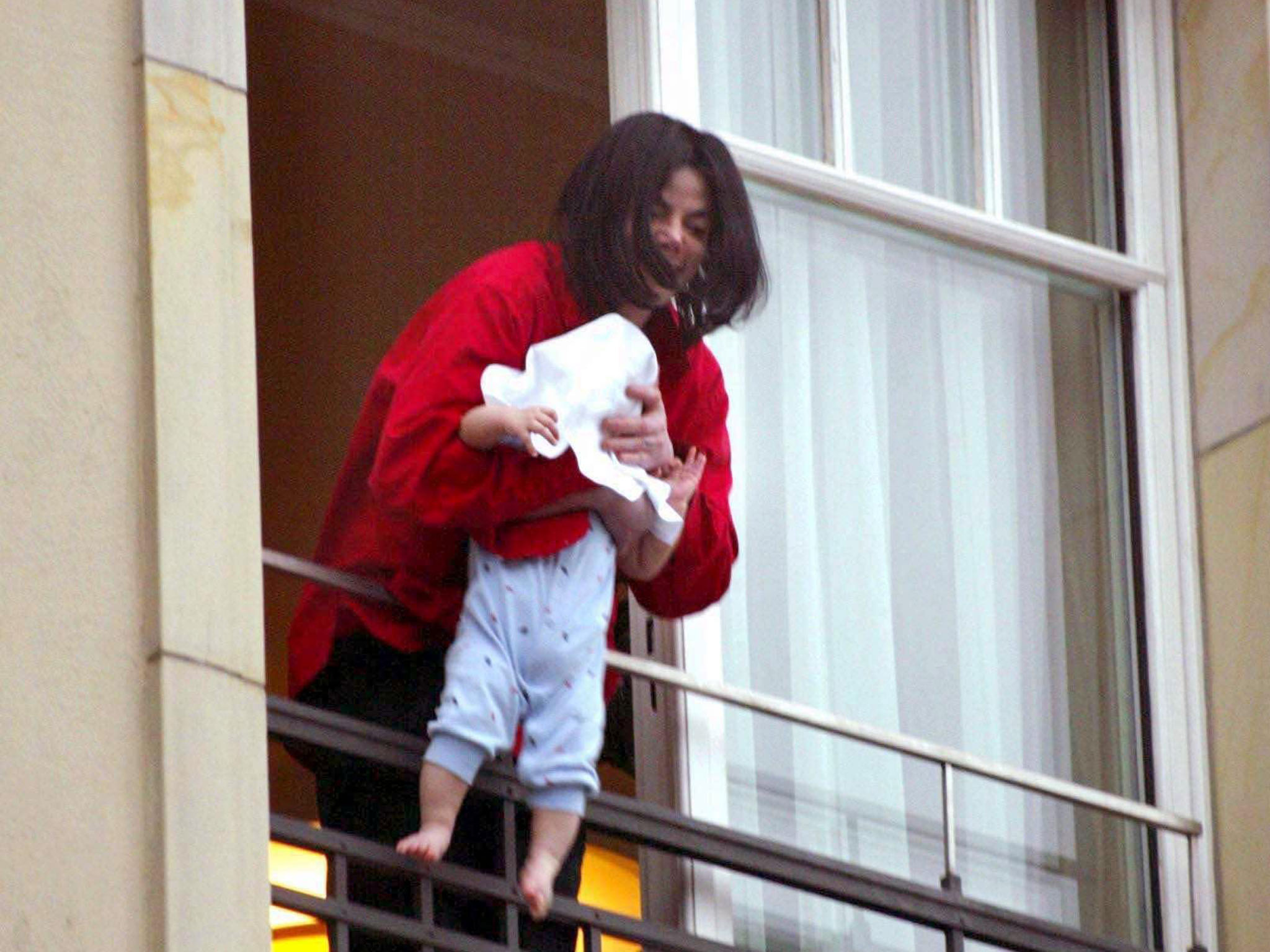 Mandatory Credit: Photo by Sipa Press/REX (396910e) Michael Jackson dangles his son Prince Michael II over a balcony of the Adlon Hotel MICHAEL JACKSON IN BERLIN, GERMANY - 19 NOV 2002