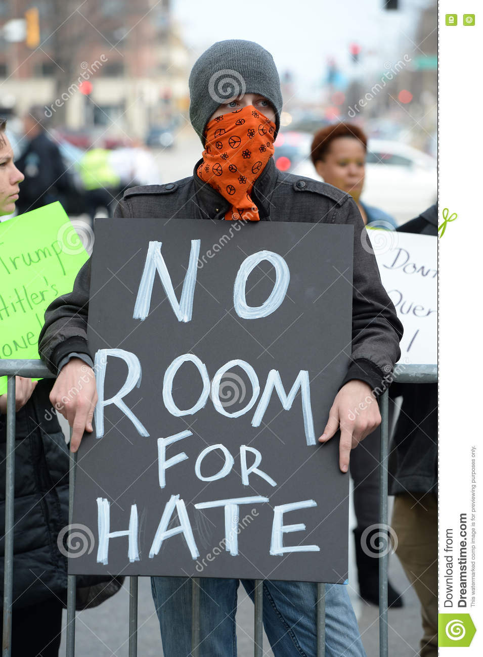 masked-protester-holding-sign-outside-trump-rally-saint-louis-mo-usa-march-hold-signs-donald-peabody-opera-house-71157398