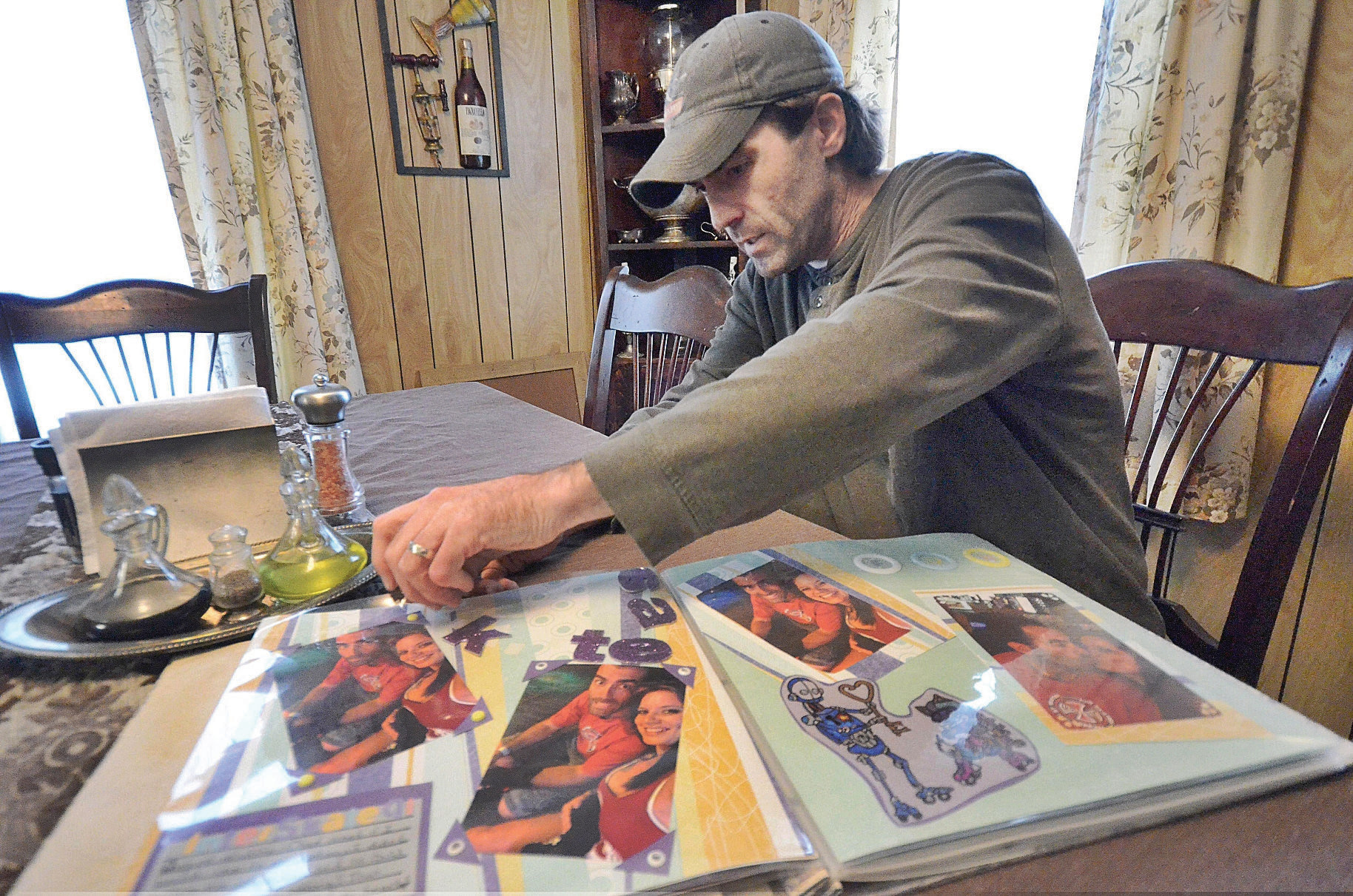 GILLIAN JONES — THE BERKSHIRE EAGLE Chad Reidy looks through an unfinished scrapbook made by his wife Joanne 'Jo' Ringer in their Clarksburg home which they have lived in together since October 2016. Ringer has been missing since March 2. Monday, March 27, 2017.